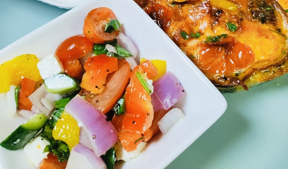 Greek style salad with feta served alongside a smoked salmon, egg and cheese air fryer breakfast bake