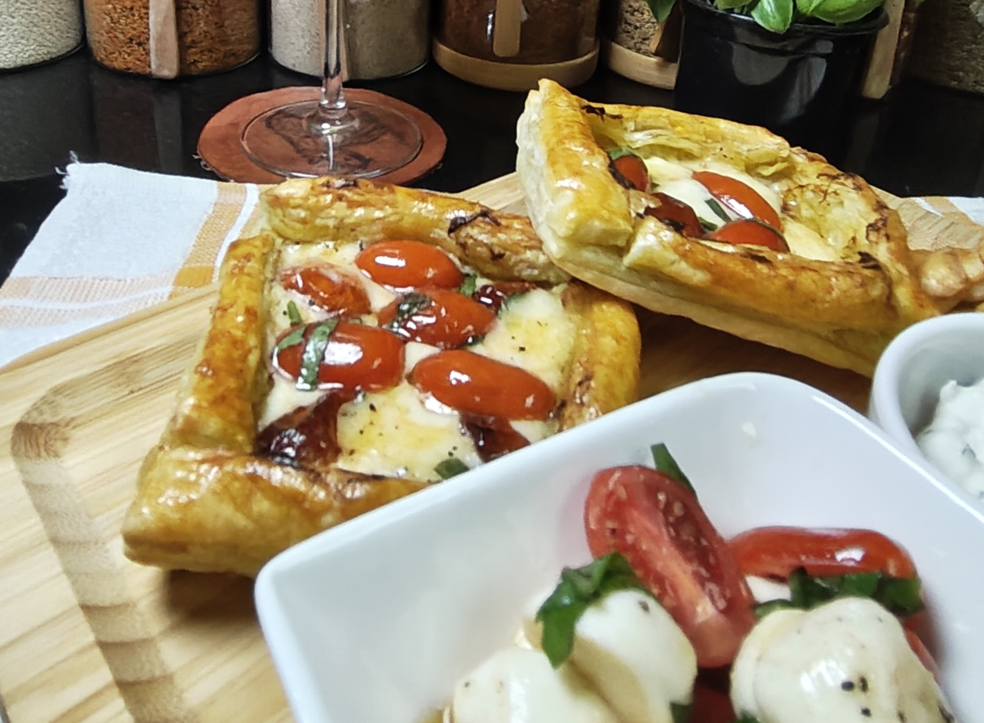 Air fryer pesto, tomato and mozzarella puff pastries served with Caprese salad