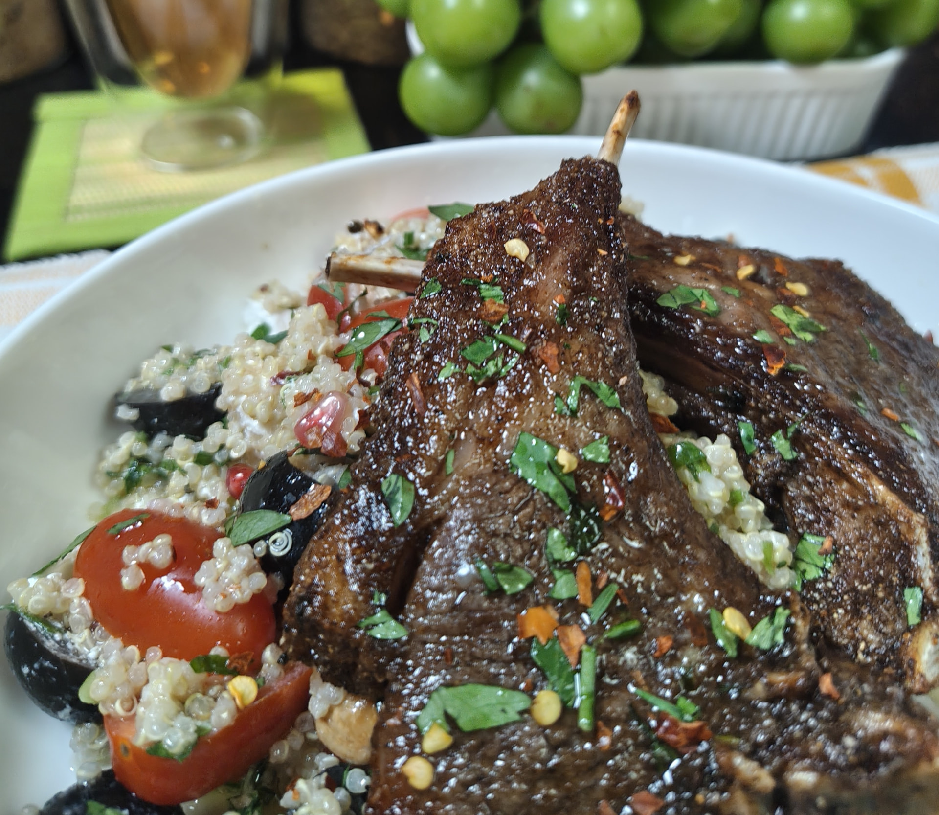 Close up of air fryer lamb chops brushed with garlic butter and topped with fresh parsley