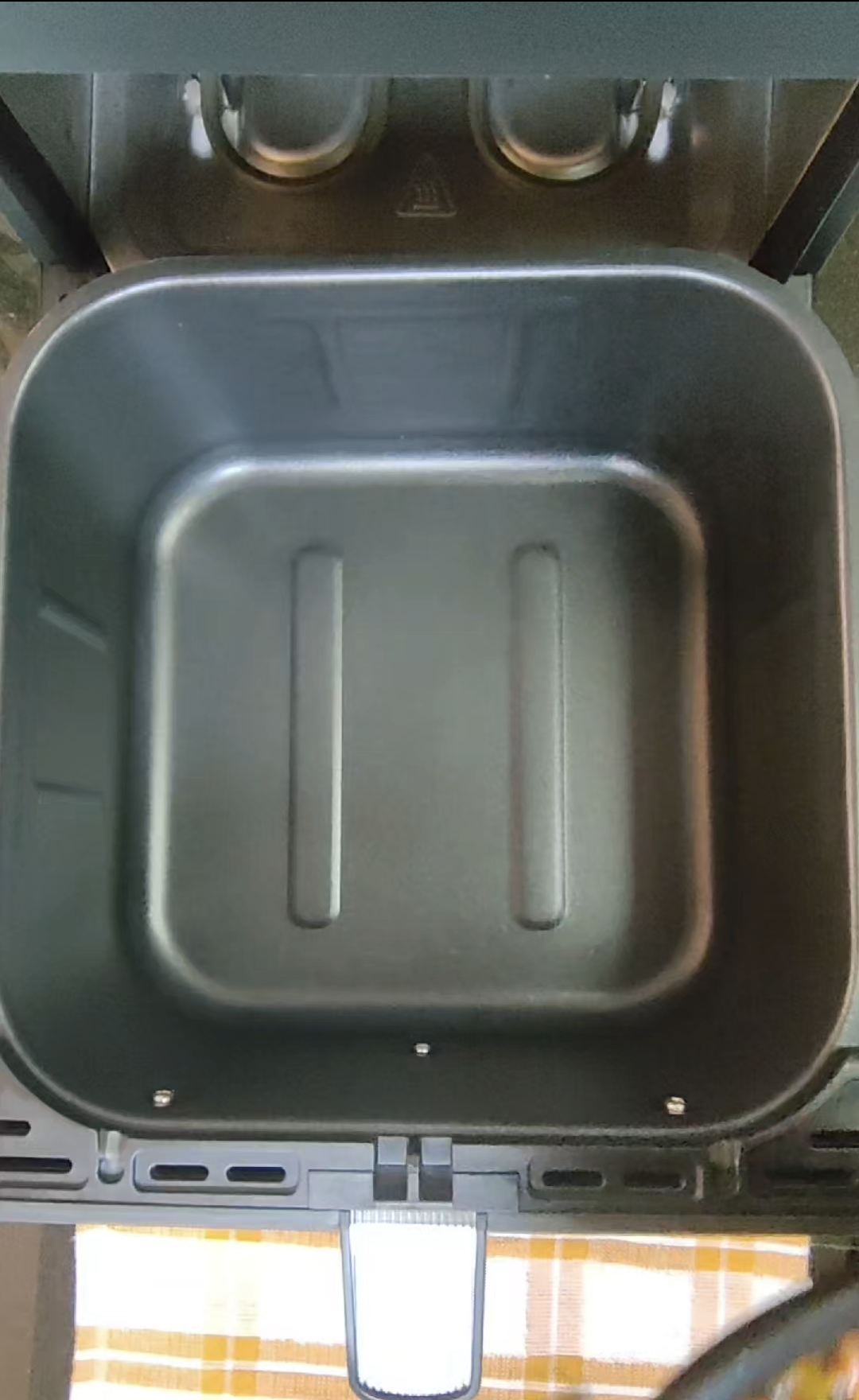 Air fryer basket with crisper plate removed for cleaning