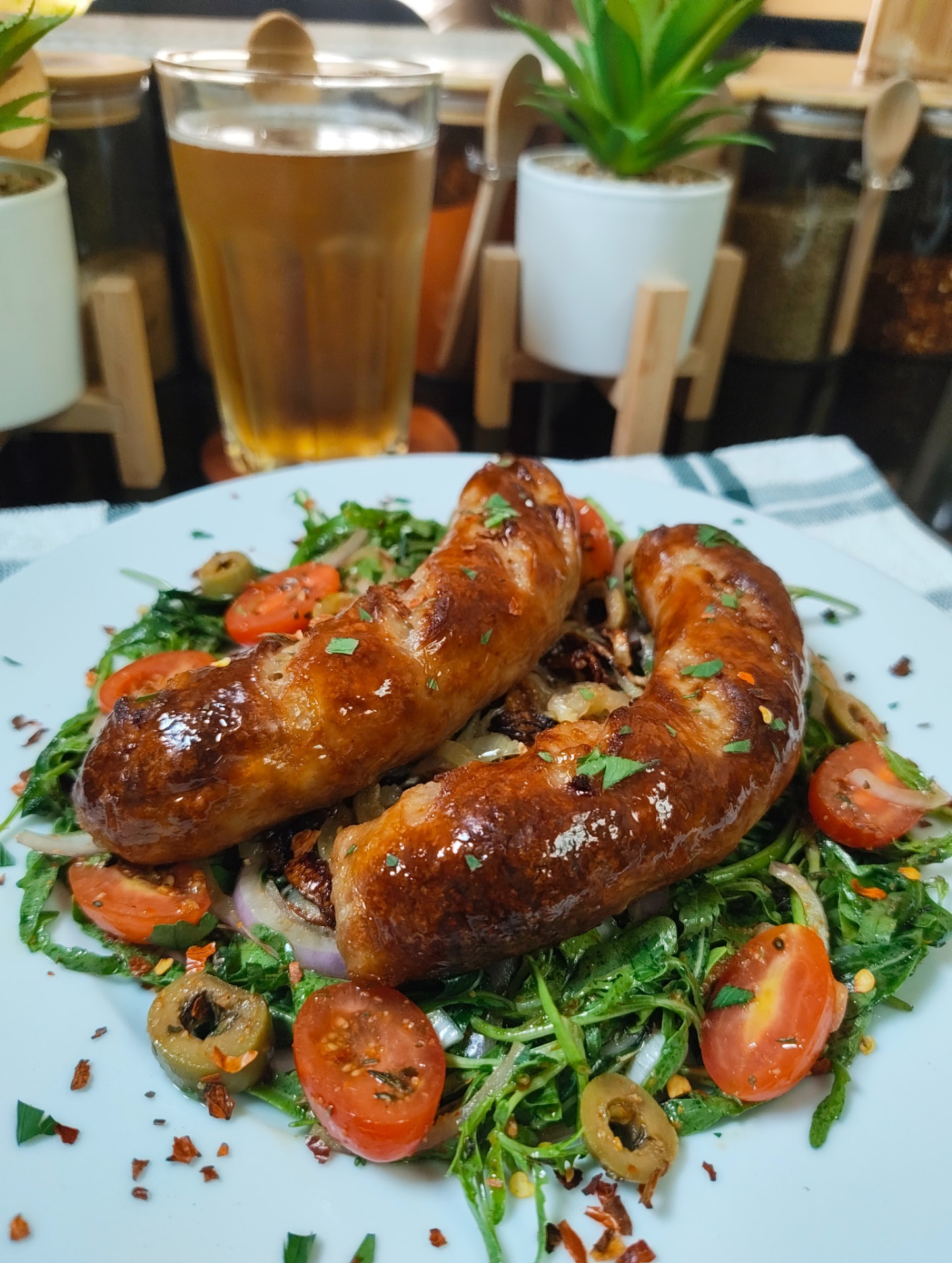 Golden air fryer chicken sausages served with fresh rocca salad