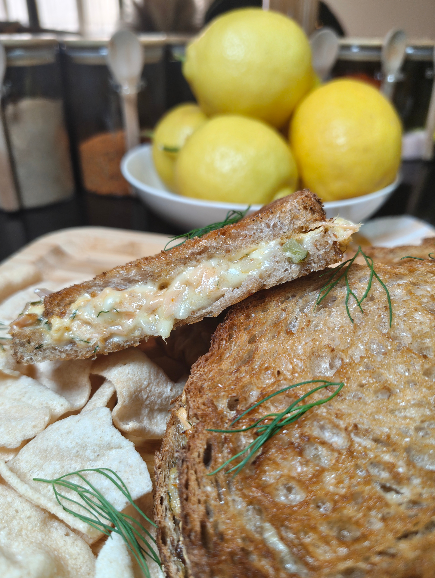 Three salmon melt sandwiches in an air fryer basket