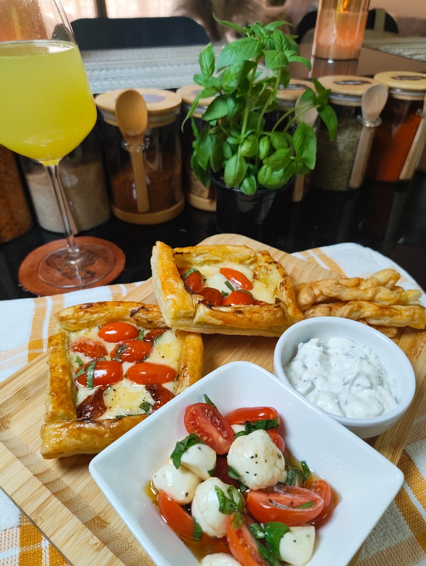Golden pesto tomato and mozzarella puff pastries served with Caprese salad