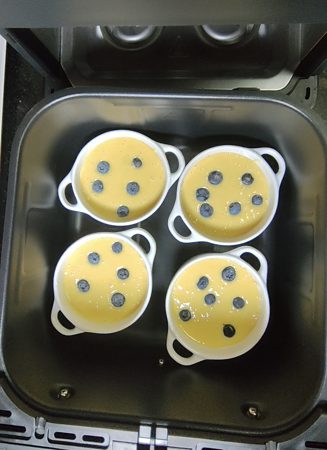 Small cooking dishes placed inside an air fryer basket