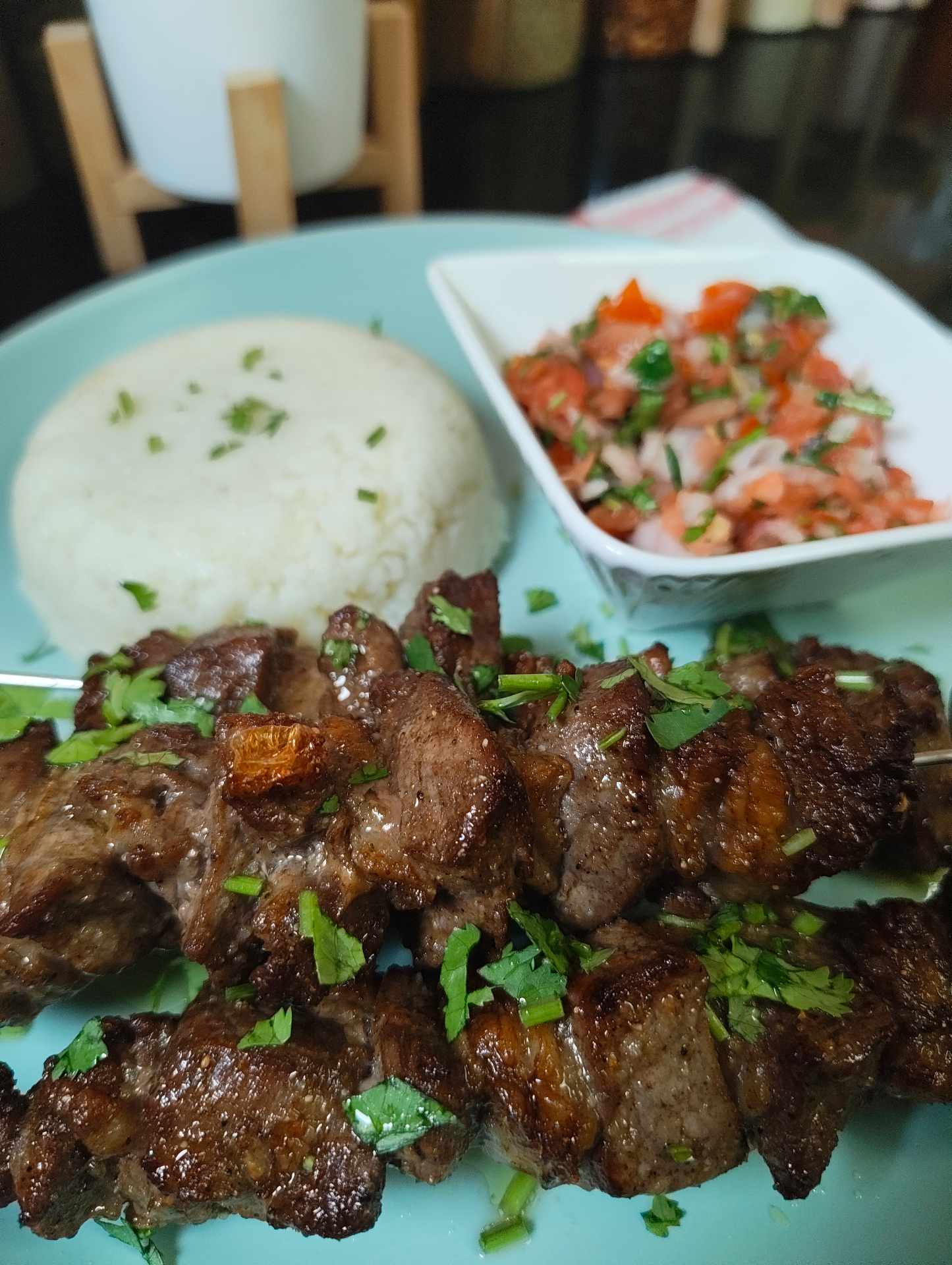Close-up of air fryer ribeye beef skewers finished with chopped fresh coriander