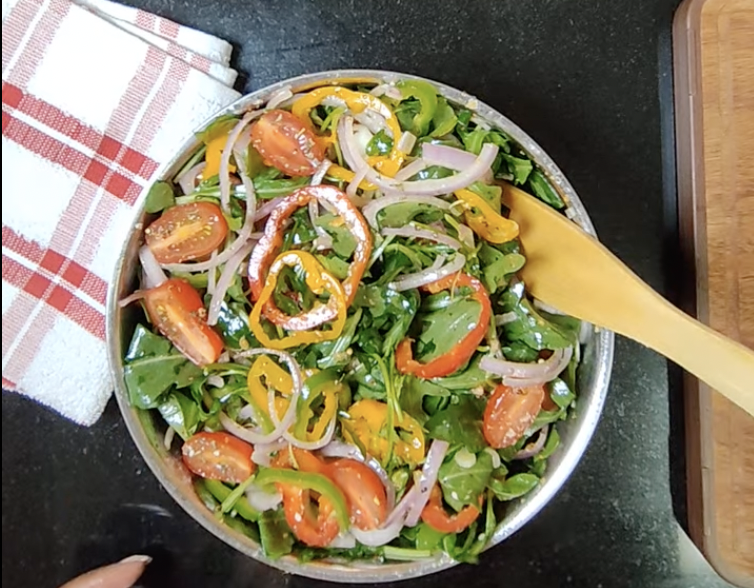 Easy rocket salad with red yellow and green bell peppers, cherry tomatoes and onion