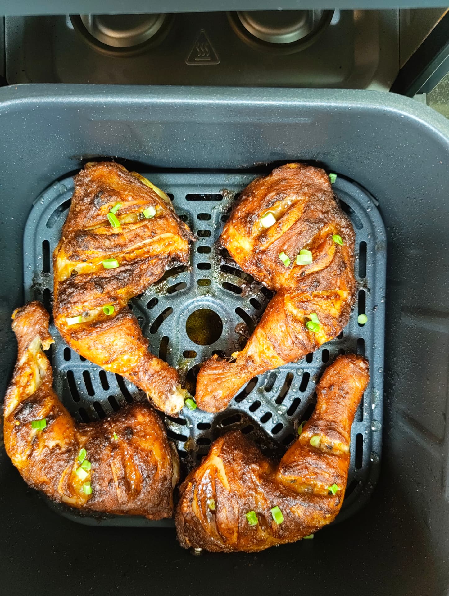 Golden seasoned chicken legs cooked in the air fryer
