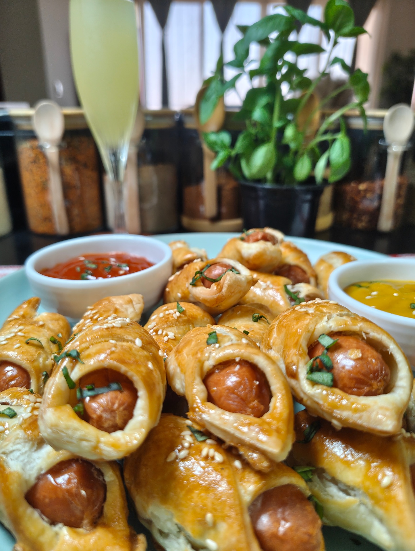 Close-up of golden mini sausage pastries on a serving plate
