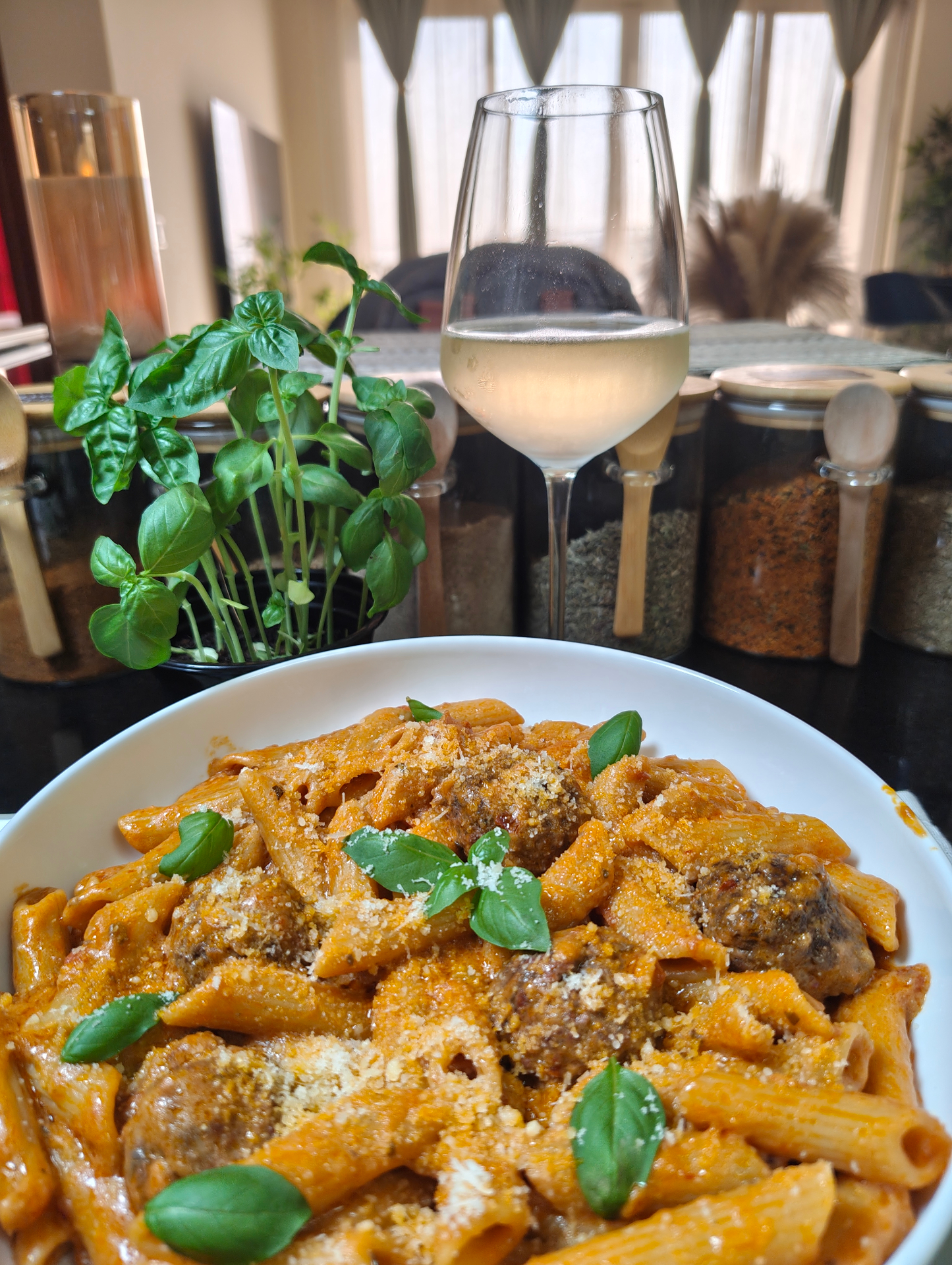 Penne with meatballs in creamy garlic tomato sauce, finished with Parmesan and fresh basil