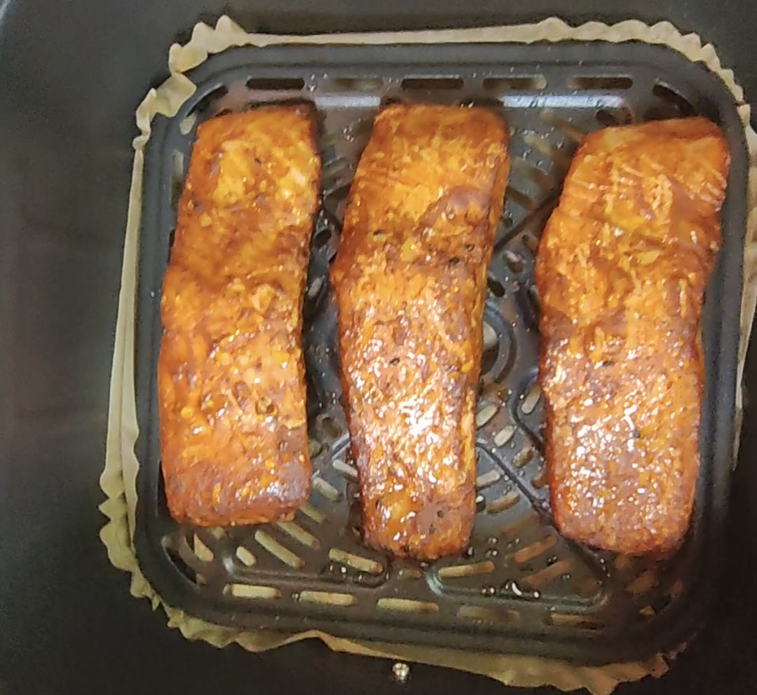 Air fryer salmon fillets cooked until golden