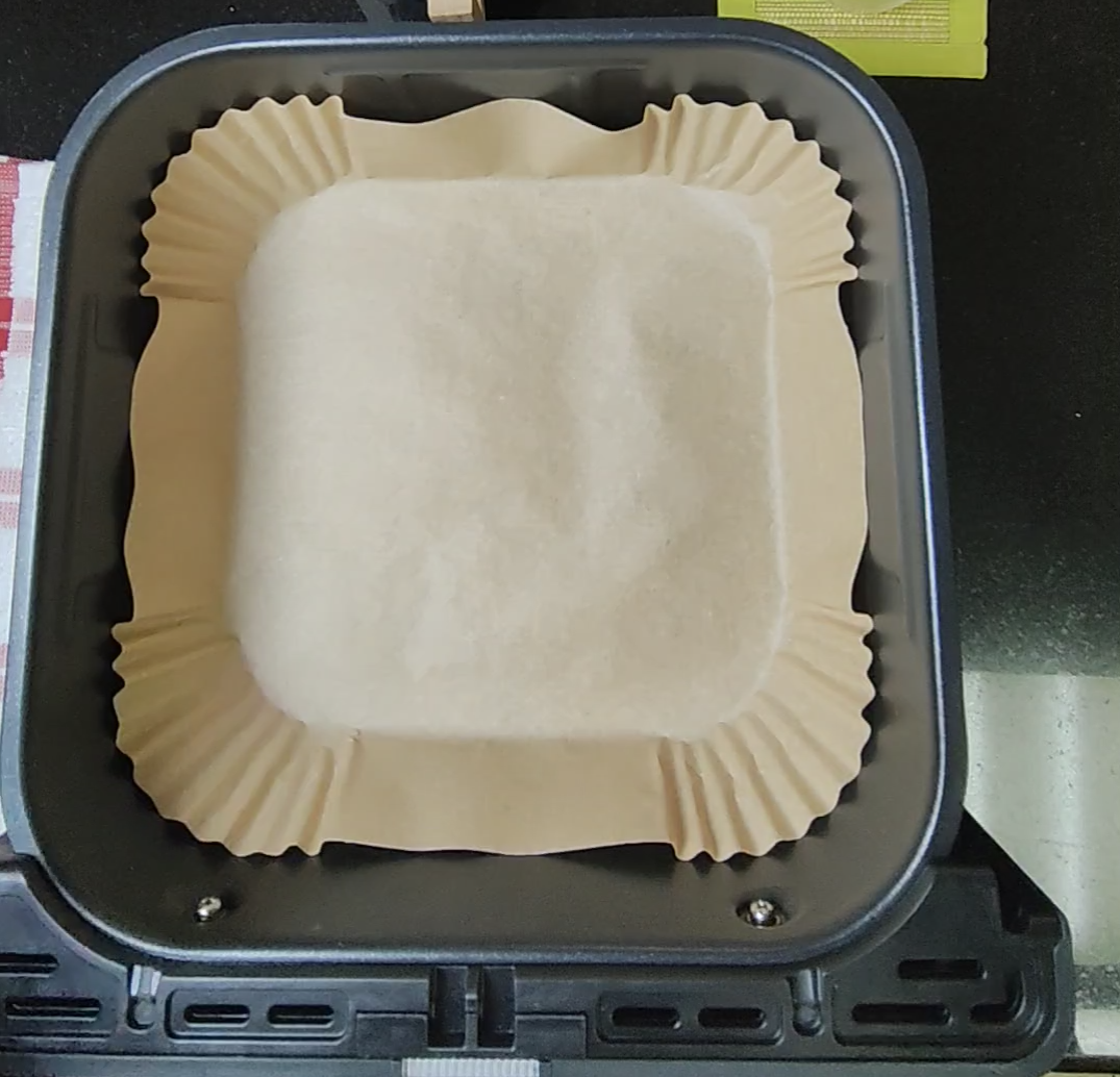 Empty parchment-style liner placed inside an air fryer basket