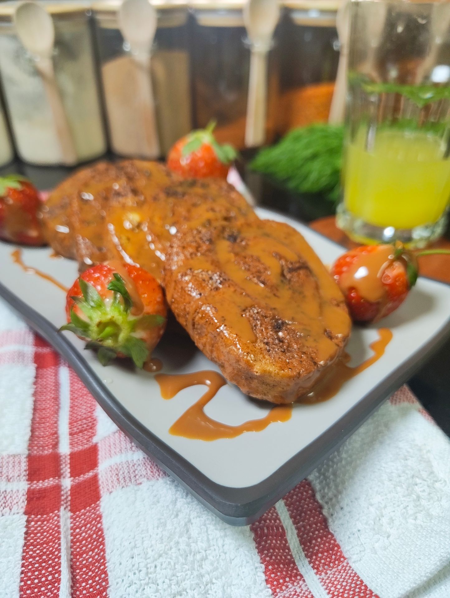 Air fryer rolled French toast with caramel sauce and fresh strawberries
