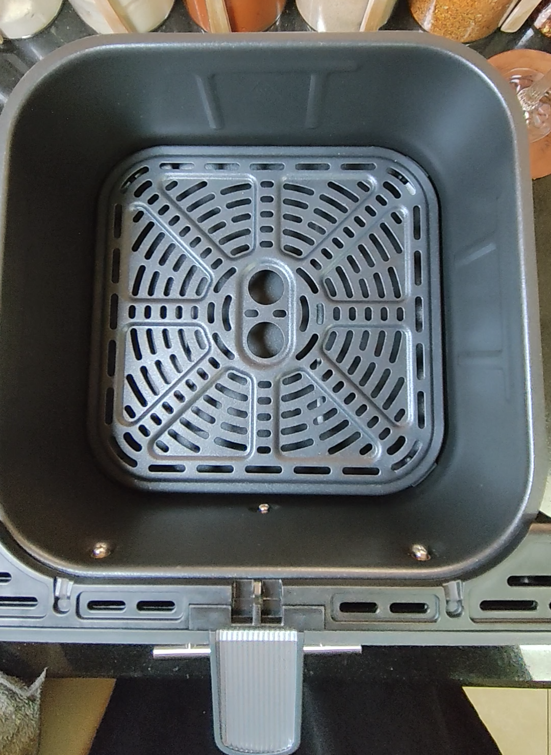 Open air fryer basket with crisper plate in place