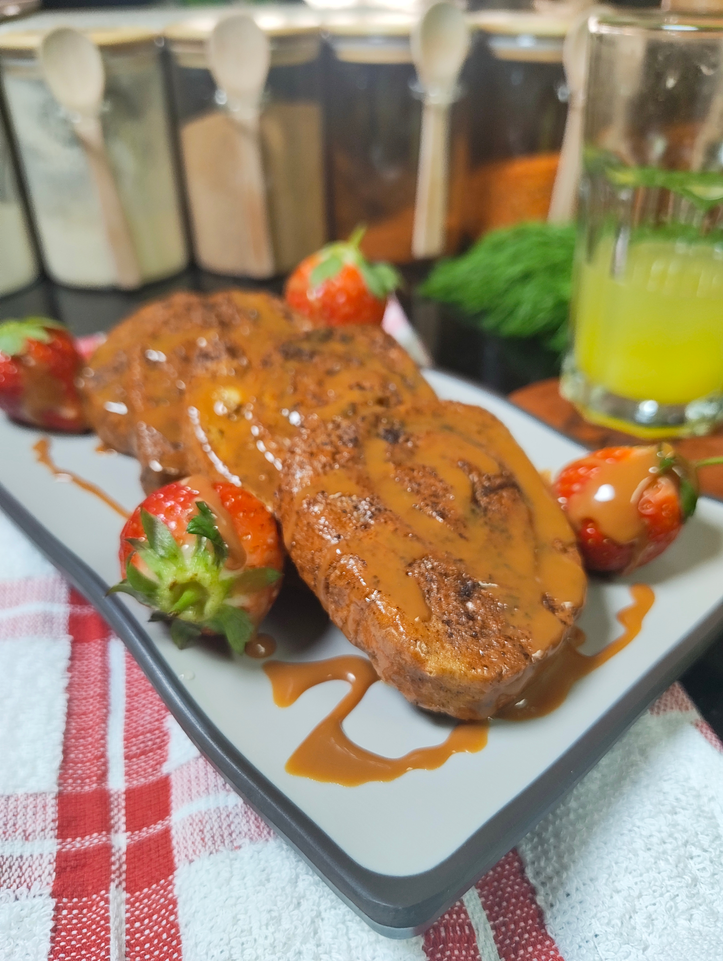 Caramel drizzled air fryer rolled French toast served with strawberries