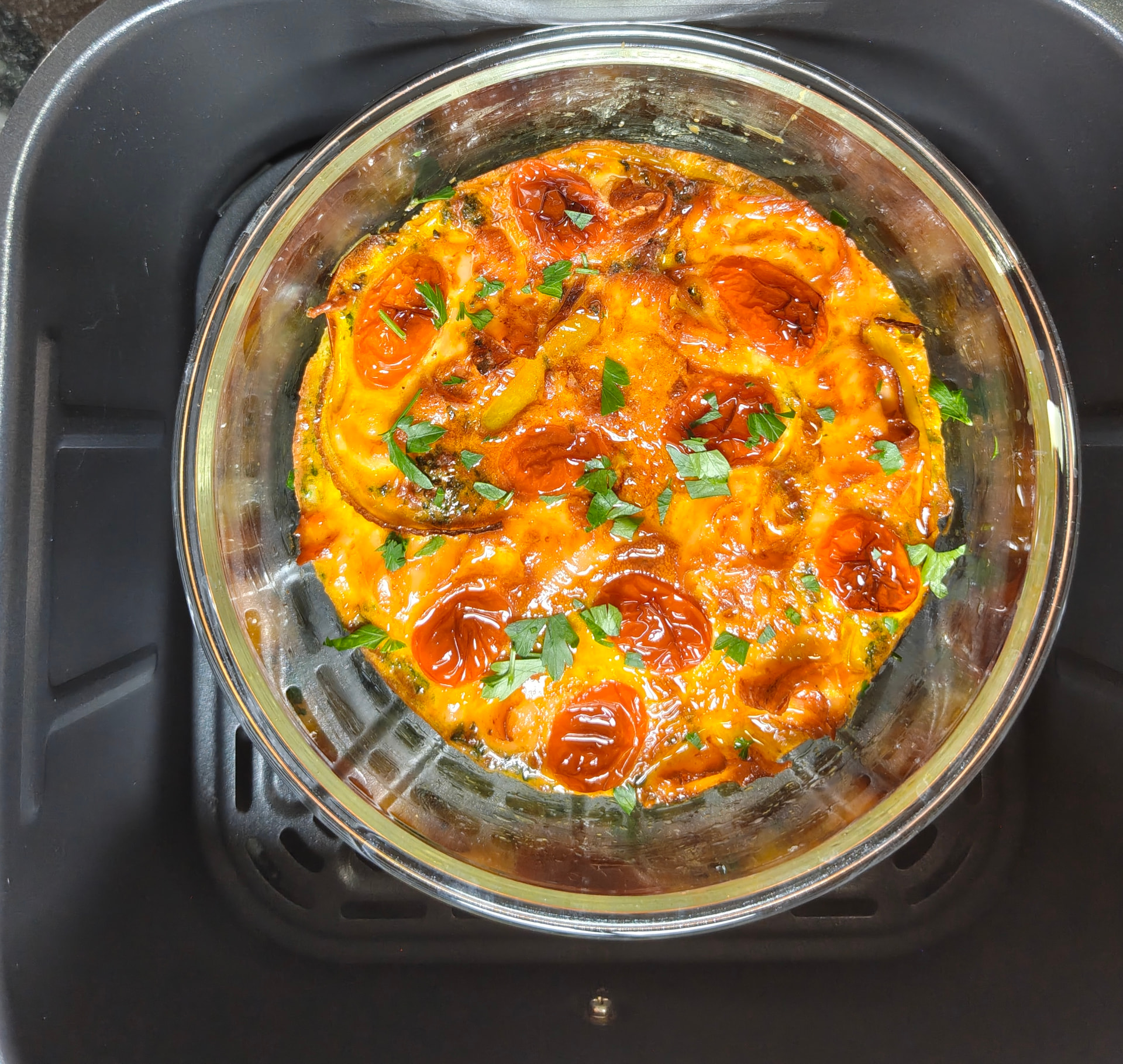 Smoked salmon and egg breakfast bake in a glass dish inside the air fryer basket