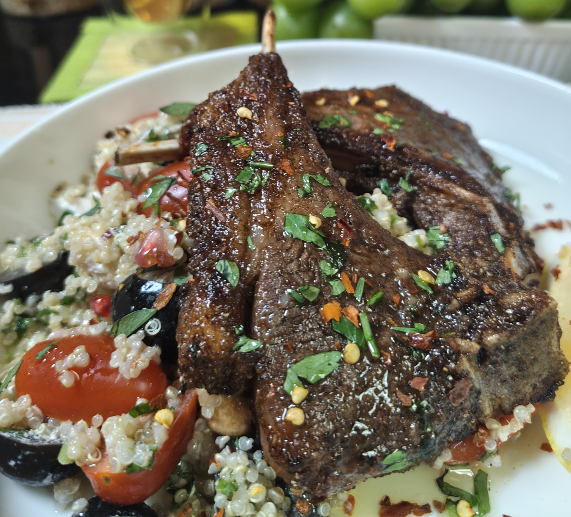 Nyama choma air fryer lamb chops garnished with parsley and chilli flakes, served with a quinoa salad