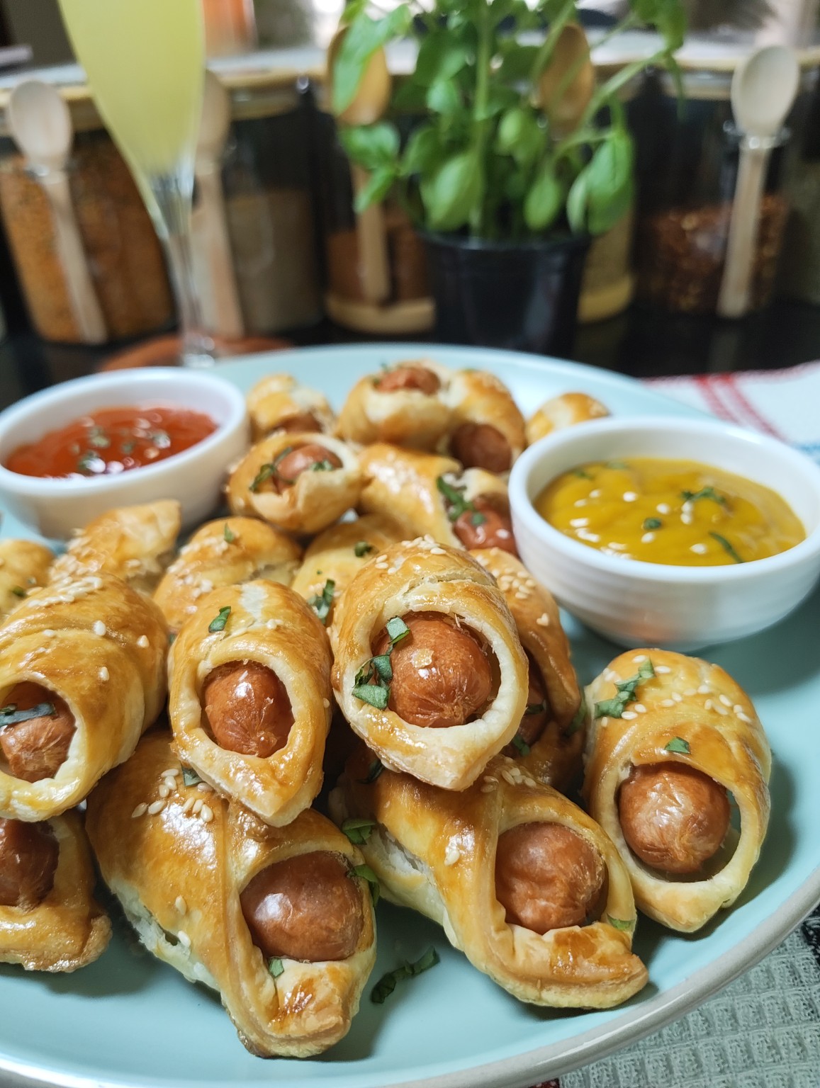 Golden air fryer mini sausage pastries piled on a serving plate