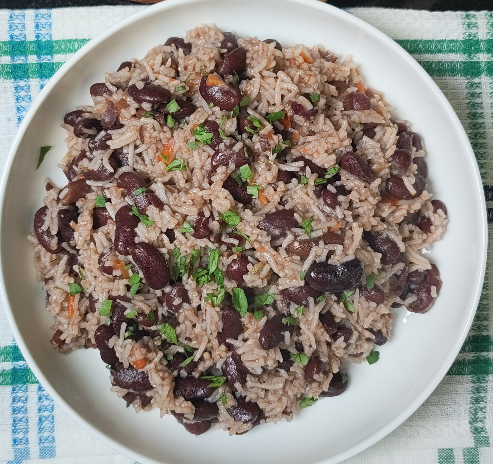 Overhead view of homemade kidney beans and rice garnished with parsley