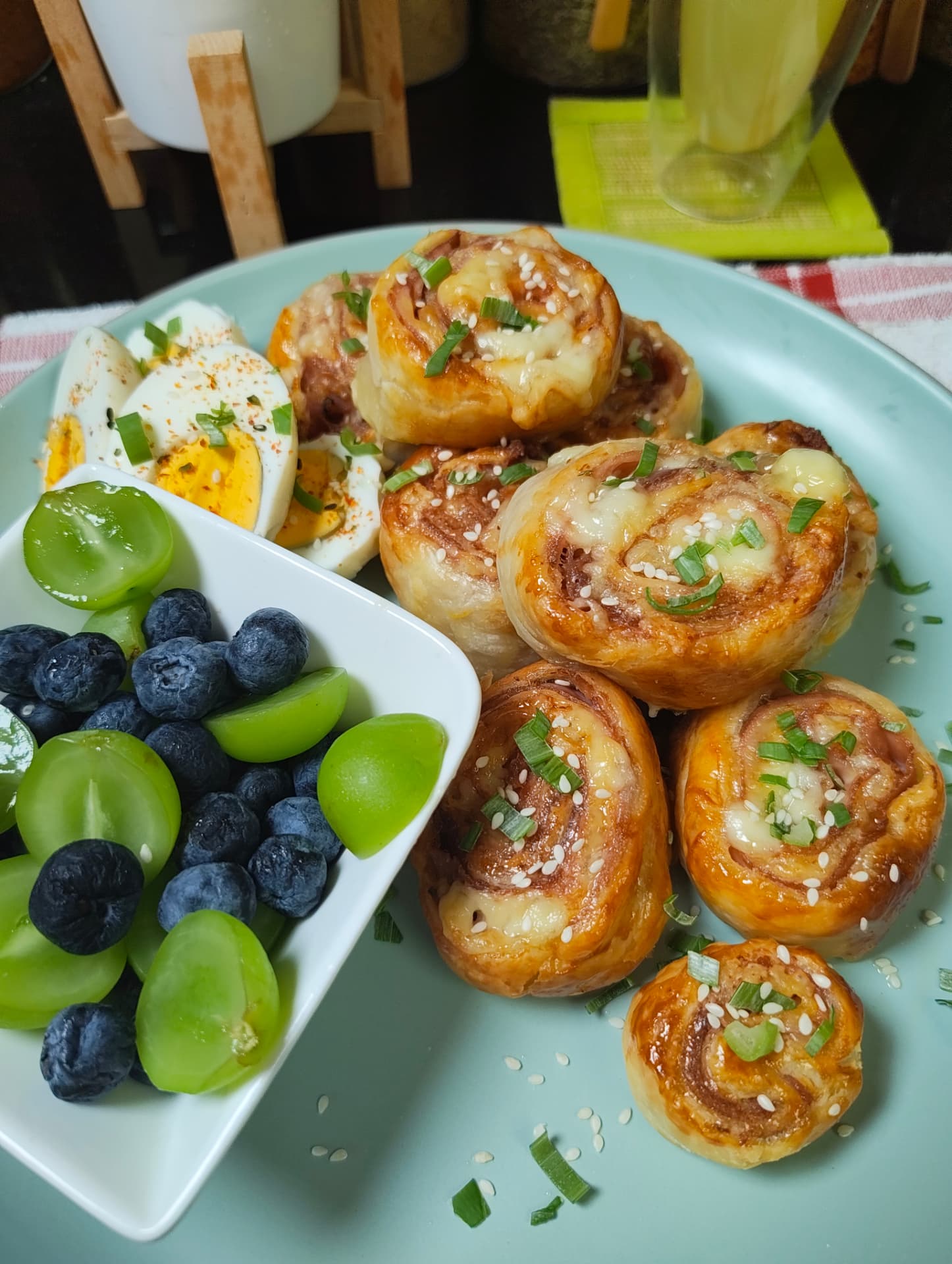 Air fryer ham and cheese pinwheels served with boiled eggs and fresh fruit for breakfast
