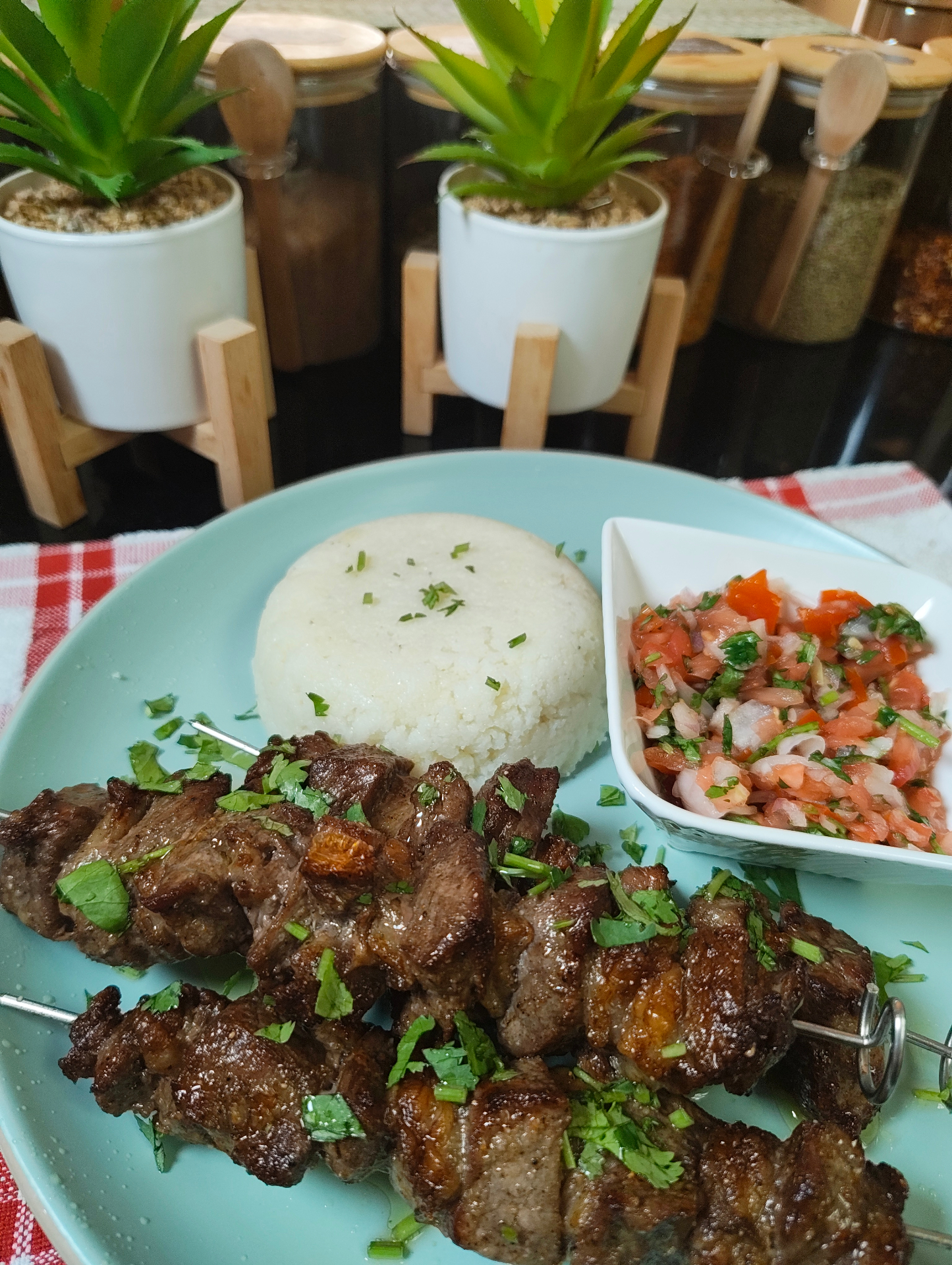 Air fryer beef skewers with ugali and fresh kachumbari on a blue plate
